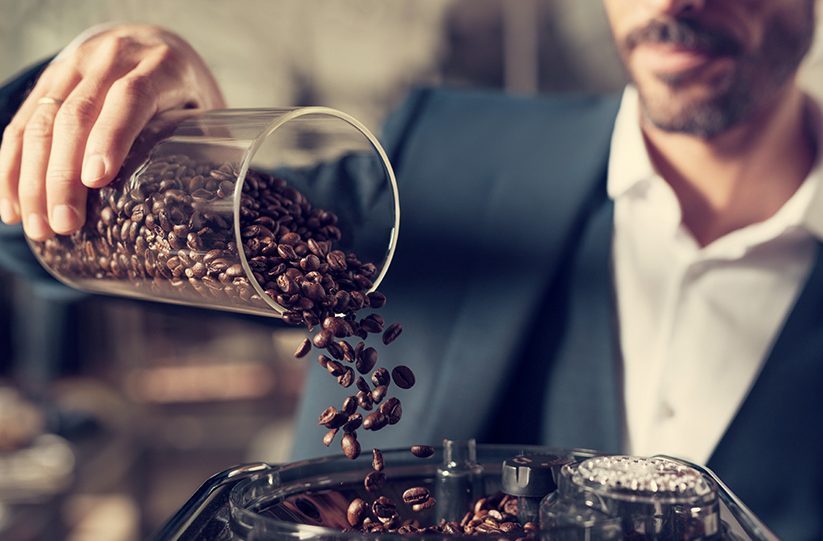 coffee beans pouring into hopper